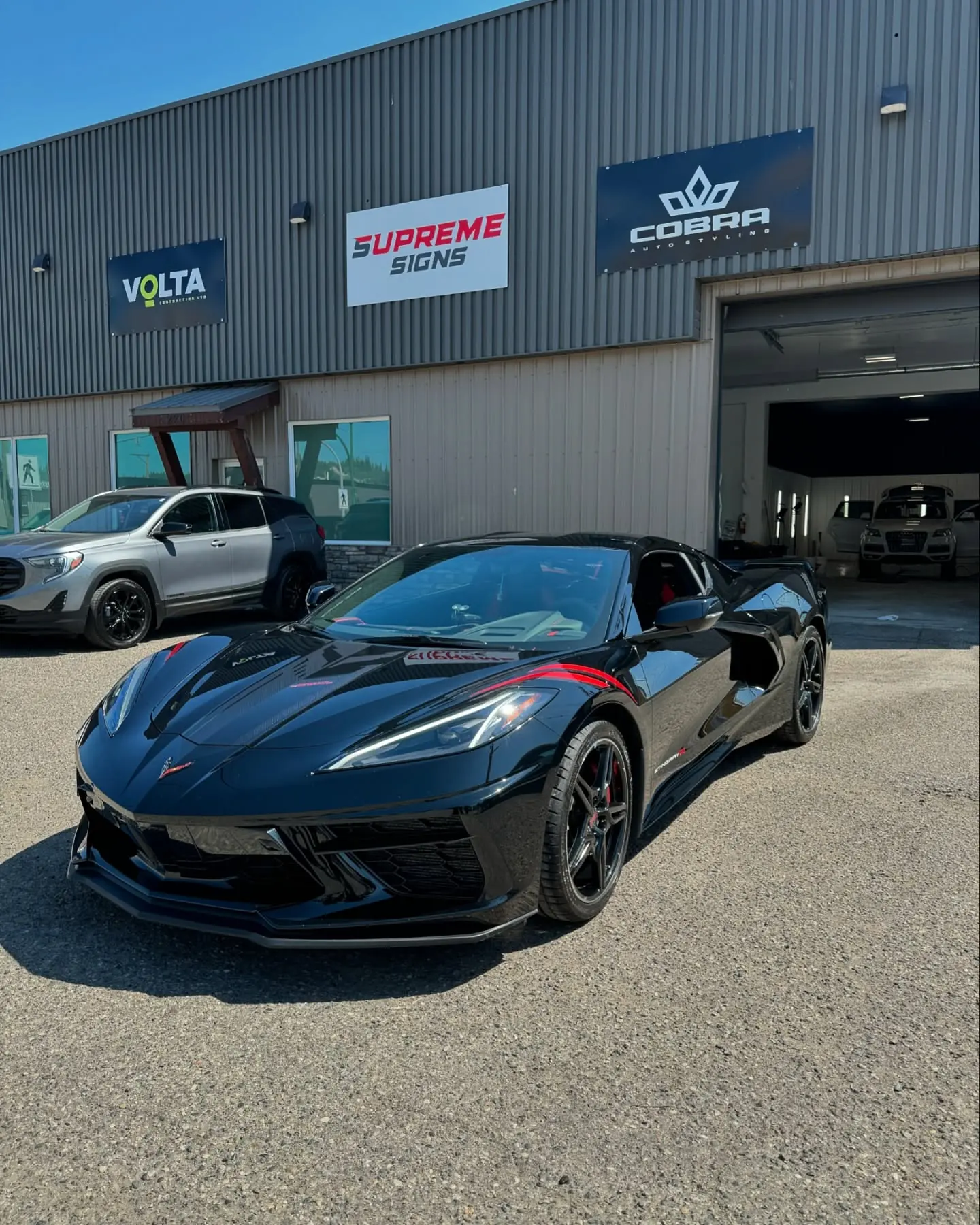 The Cobra Auto Styling shop at 220 Queensway, Prince George, with a black Corvette parked out front